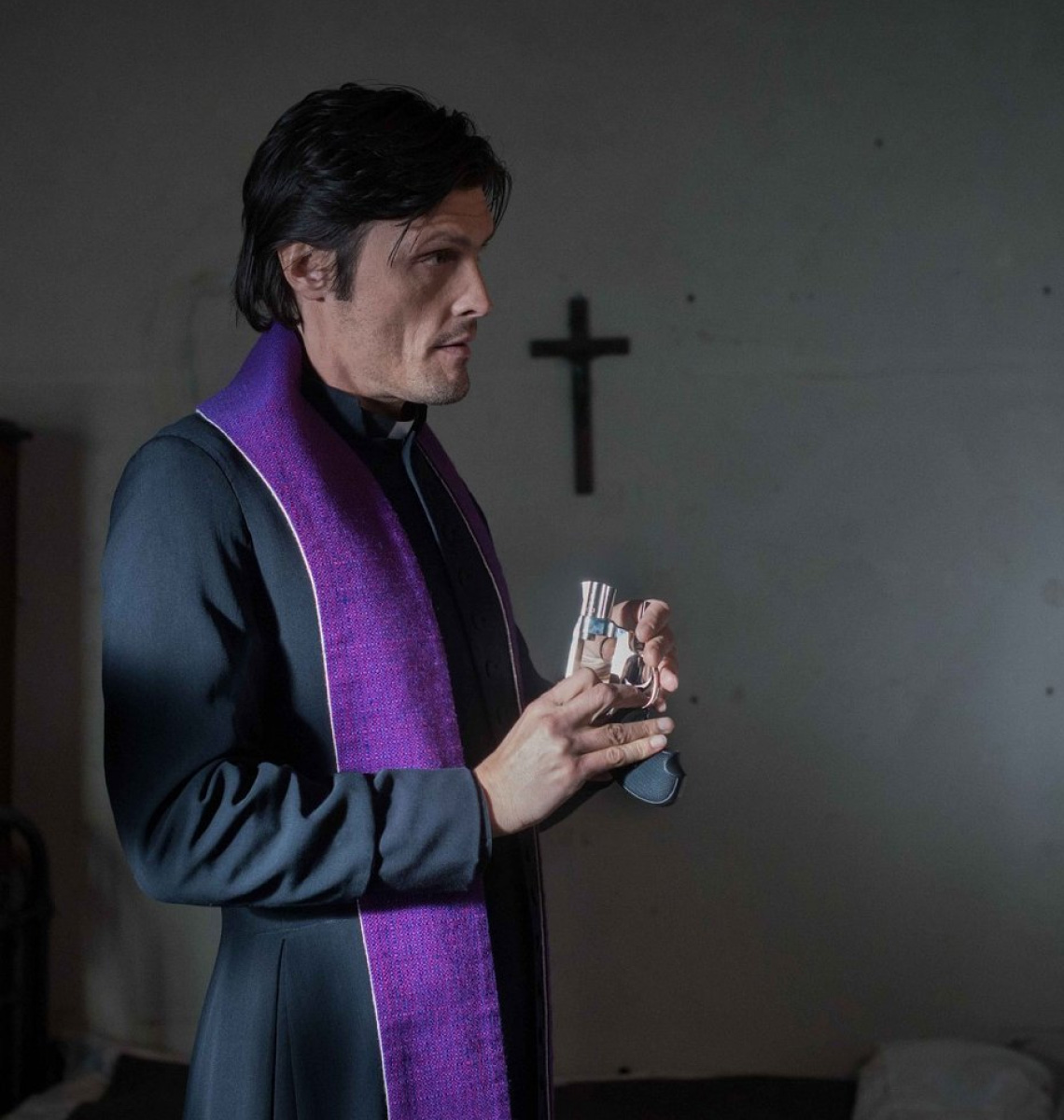 A priest wears a purple stole.